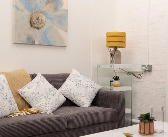 Grey sofa with cushions and lamp