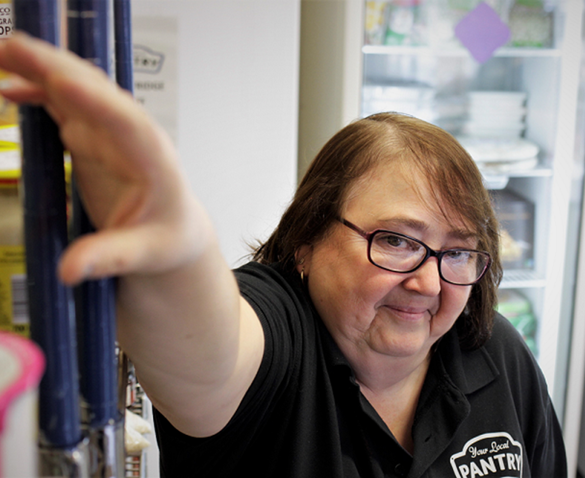 Maz filling shelves at Your Local Pantry