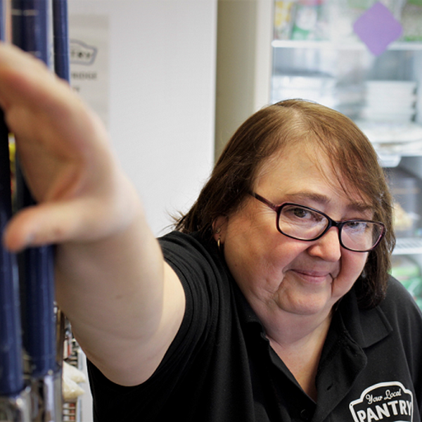 Maz filling shelves at Your Local Pantry