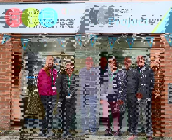 SKylight colleagues stood in front of furniture storage unit