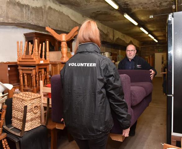 Volunteers carrying a sofa